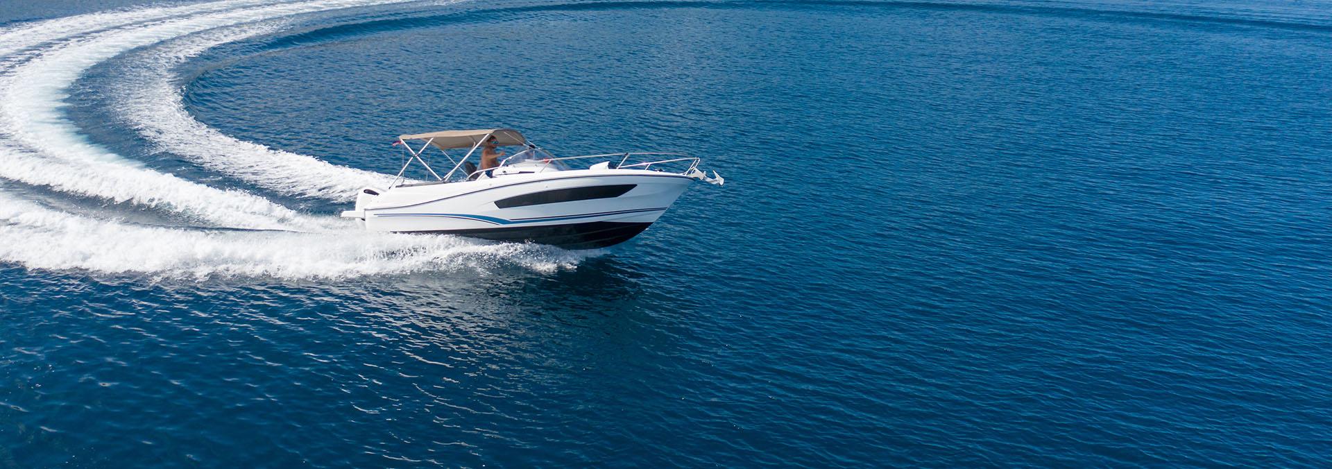 Yacht speeding on open waters with a person aboard.