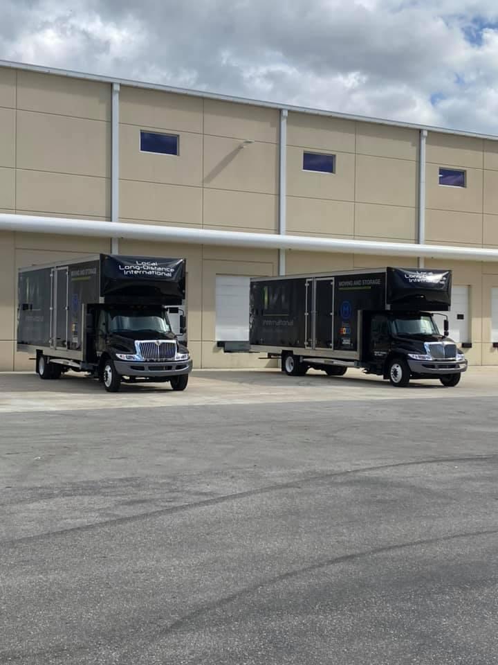 Innternational Van Lines moving trucks in front of a building