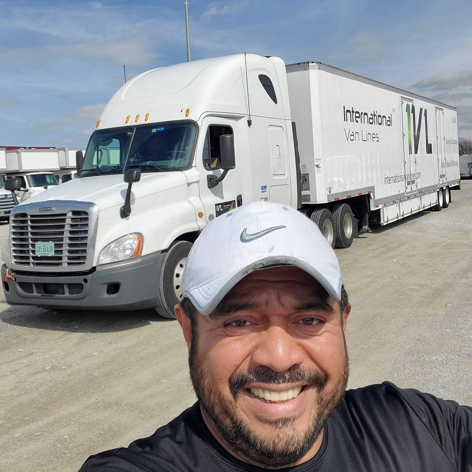 International Van Lines employee standing in front of a moving truck